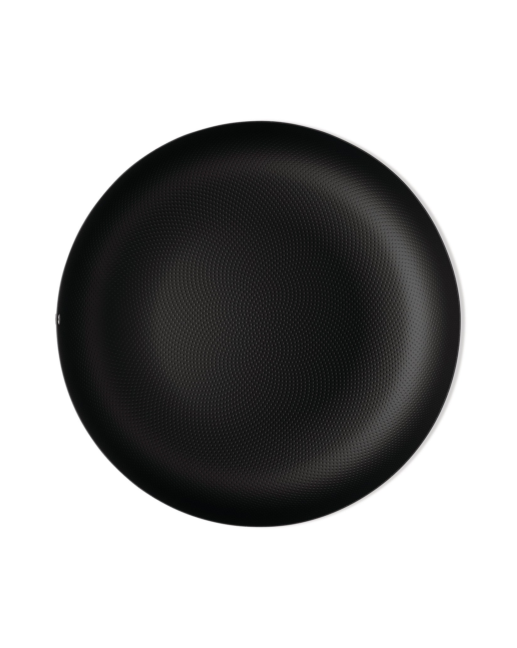 Black round plate by Alessi with a textured dimpled surface and thin white rim.