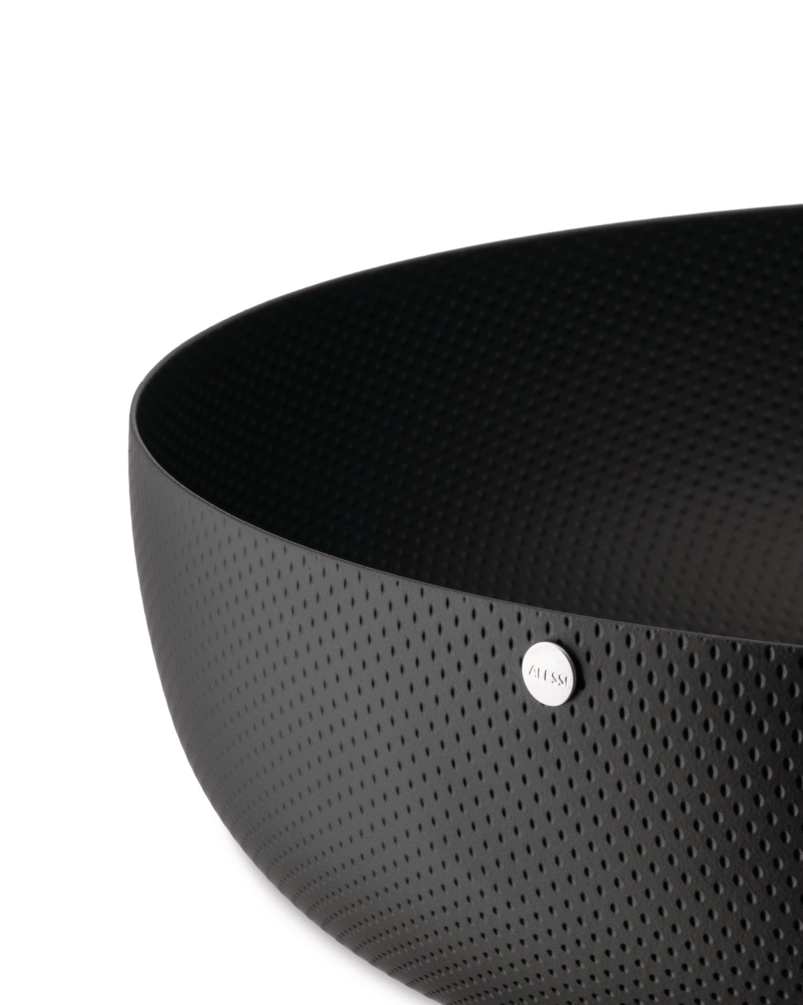 Black perforated bowl by Alessi with a silver logo badge, shown in a close-up, cropped view.