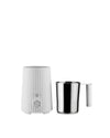 White ribbed milk frother by Alessi with a control dial and a separate stainless steel pitcher.