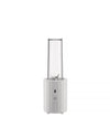 White portable blender by Alessi with a clear ribbed cup and a faceted base featuring a power button.