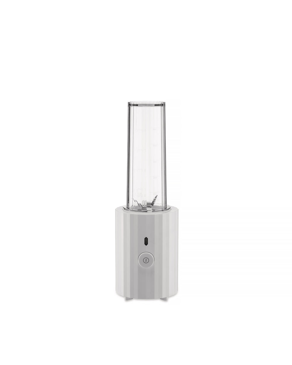 White portable blender by Alessi with a clear ribbed cup and a faceted base featuring a power button.