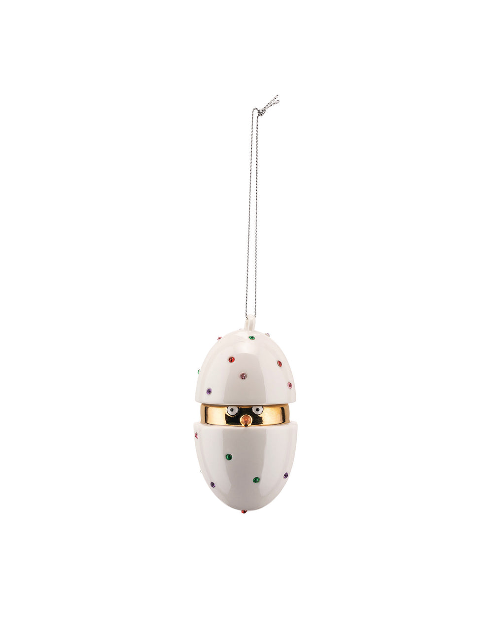 A white egg-shaped hanging ornament by Alessi, decorated with colorful studded dots, a gold band, and a chick's face peeking out.