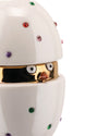 White ceramic chick egg container by Alessi, with a golden interior, colorful crystal embellishments, and a chick's face peeking out.