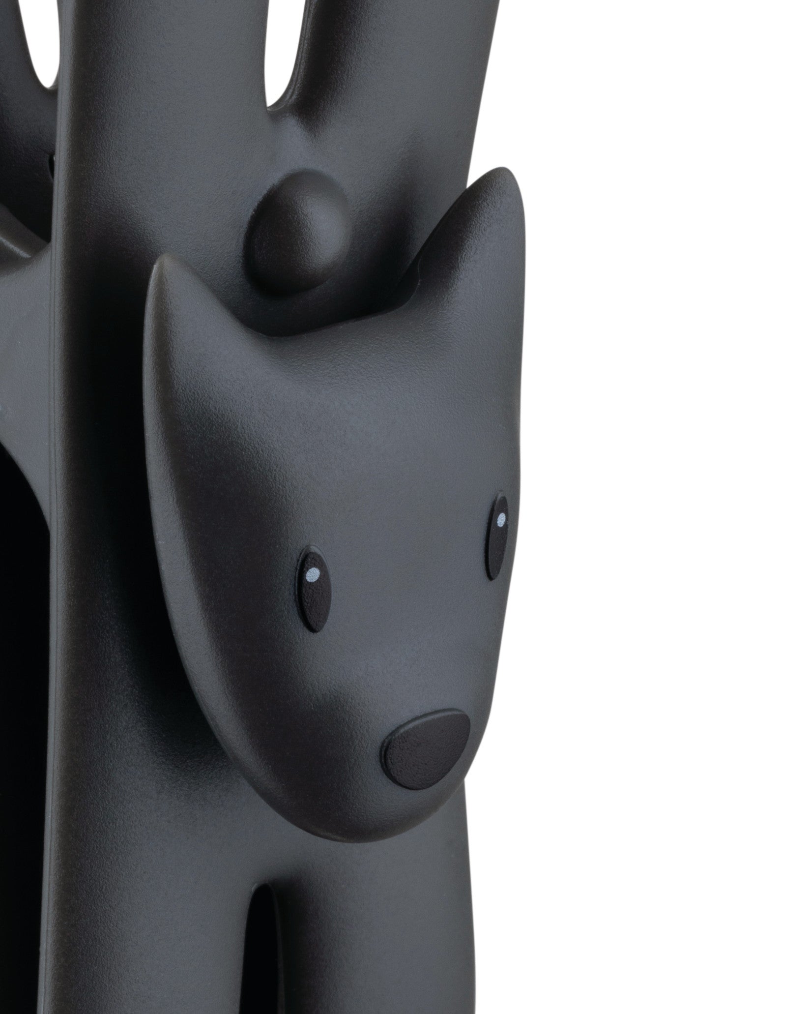 Dark gray Giampo animal figure by Alessi, with a matte texture, simple black eyes, and a black nose.