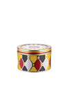 Round metal container by Alessi with a colorful harlequin diamond pattern and a clown face on the lid.