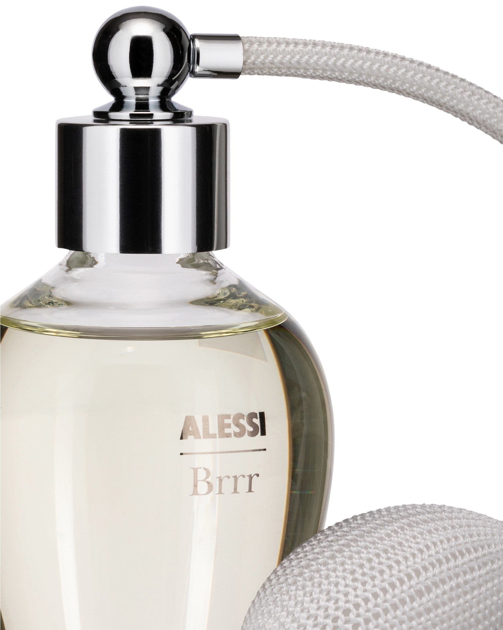 Clear glass fragrance diffuser by Alessi with 'Alessi Brrr' text, amber liquid, chrome top, and white braided rope.