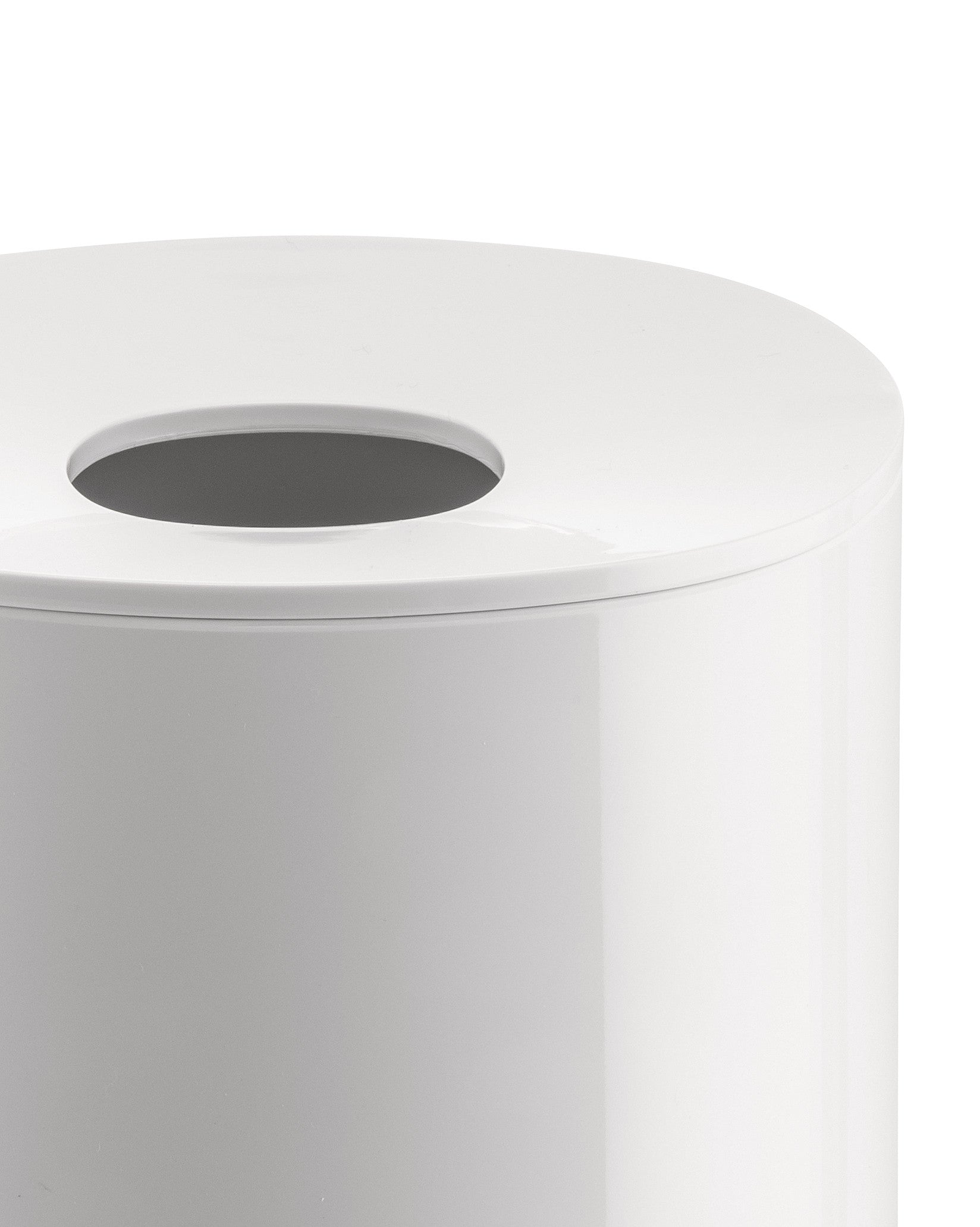 White cylindrical container by Alessi with an oval opening on the top lid, close-up.