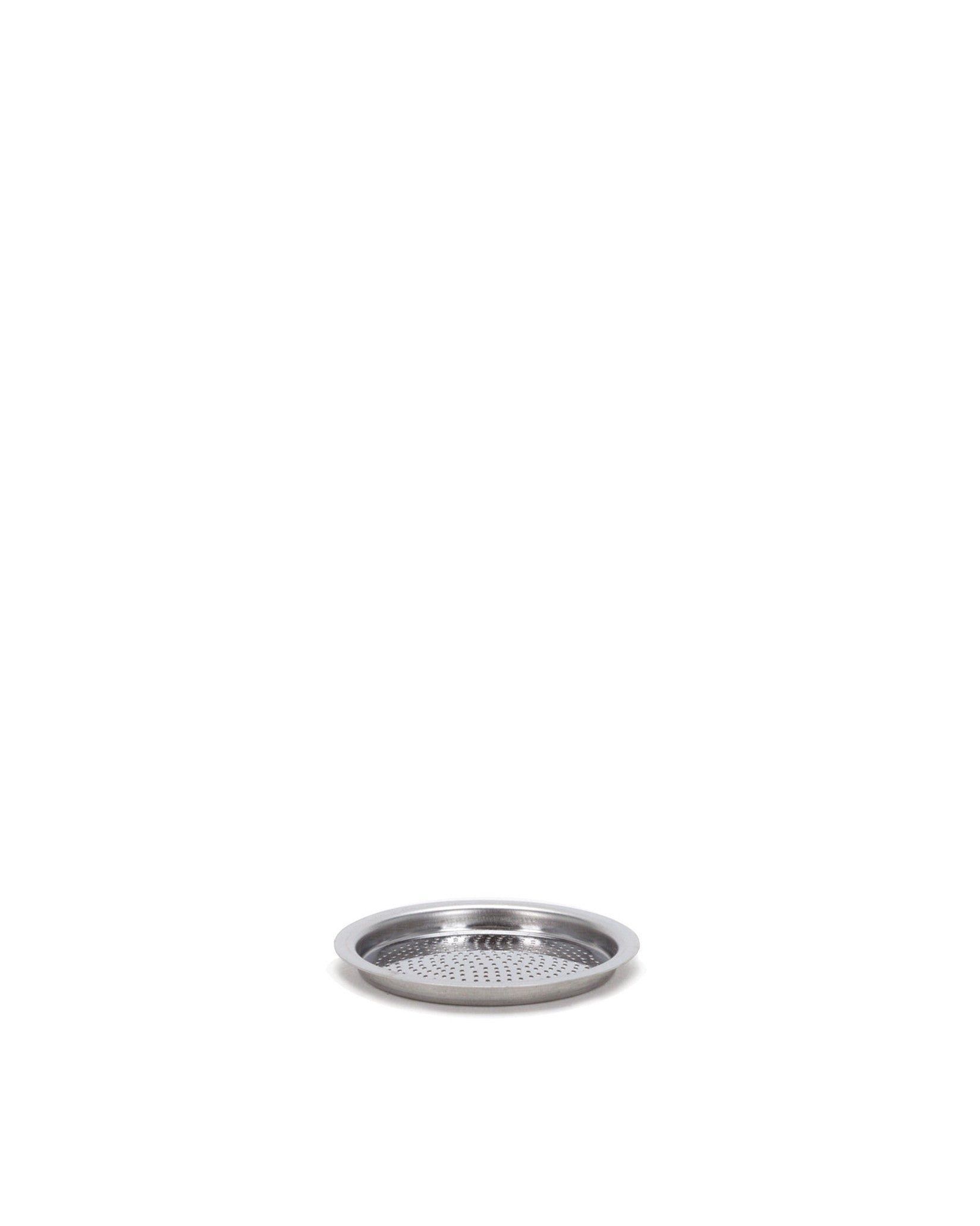 Perforated silver metal spare part by Alessi, with a raised rim and small holes, angled view.