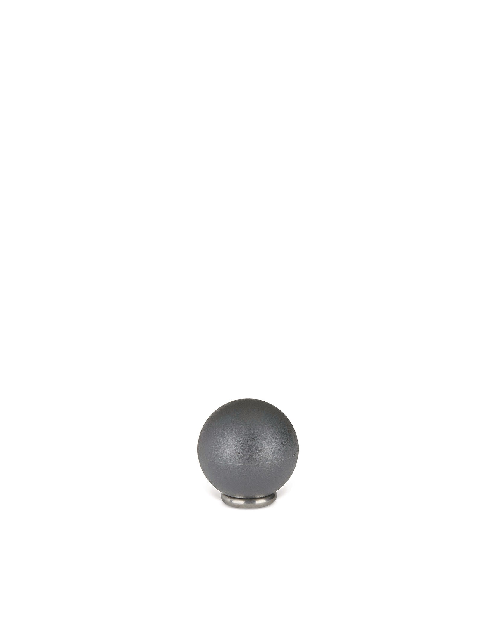 Dark gray spherical spare part by Alessi with a matte texture on a polished metal base.