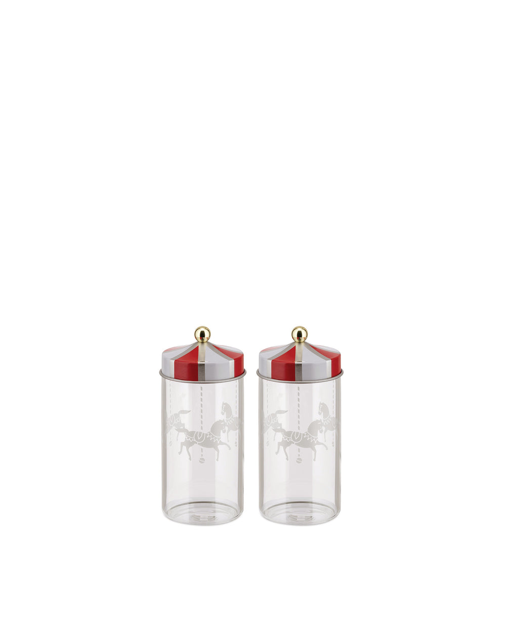 Two clear glass jars with red and white striped lids by Alessi, featuring a gold knob and carousel horse etching.