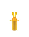 Orange bunny with yellow ears peeking from a yellow top hat by Alessi, with cartoon white eyes.