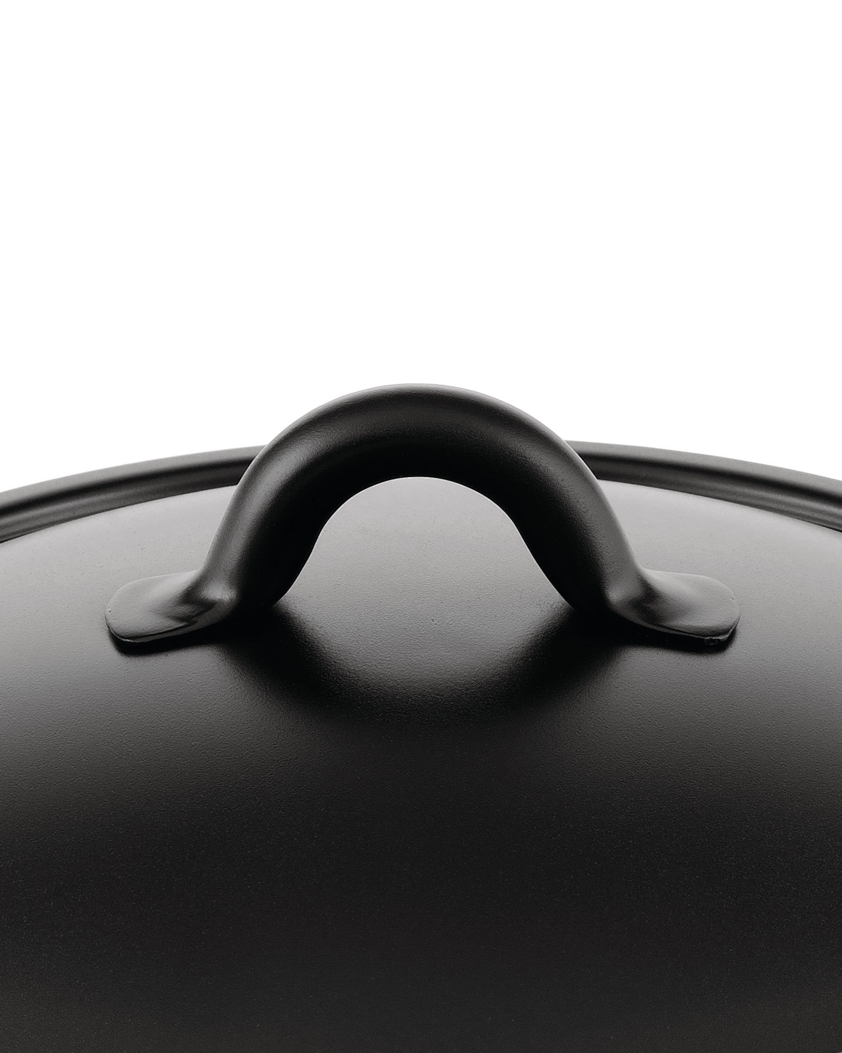 Black matte pot lid by Alessi with a curved handle and slightly textured surface, seen from a top-down view.