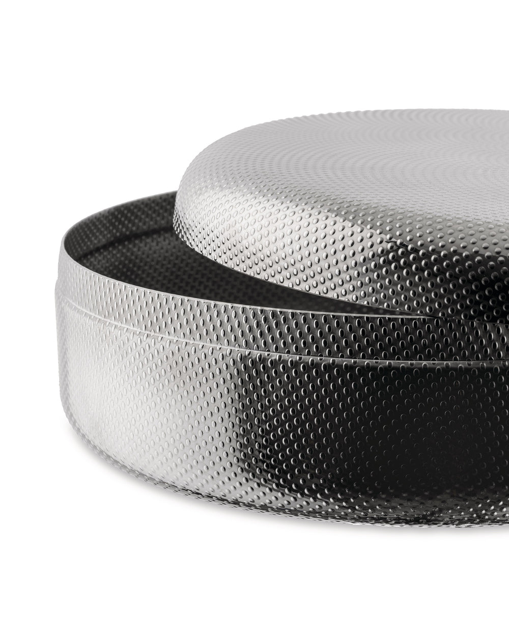 Silver round metal container by Alessi with perforated texture and slightly open lid.