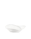 White sculptural fruit bowl by Alessi with an open, wavy linear design, angled on a white background.