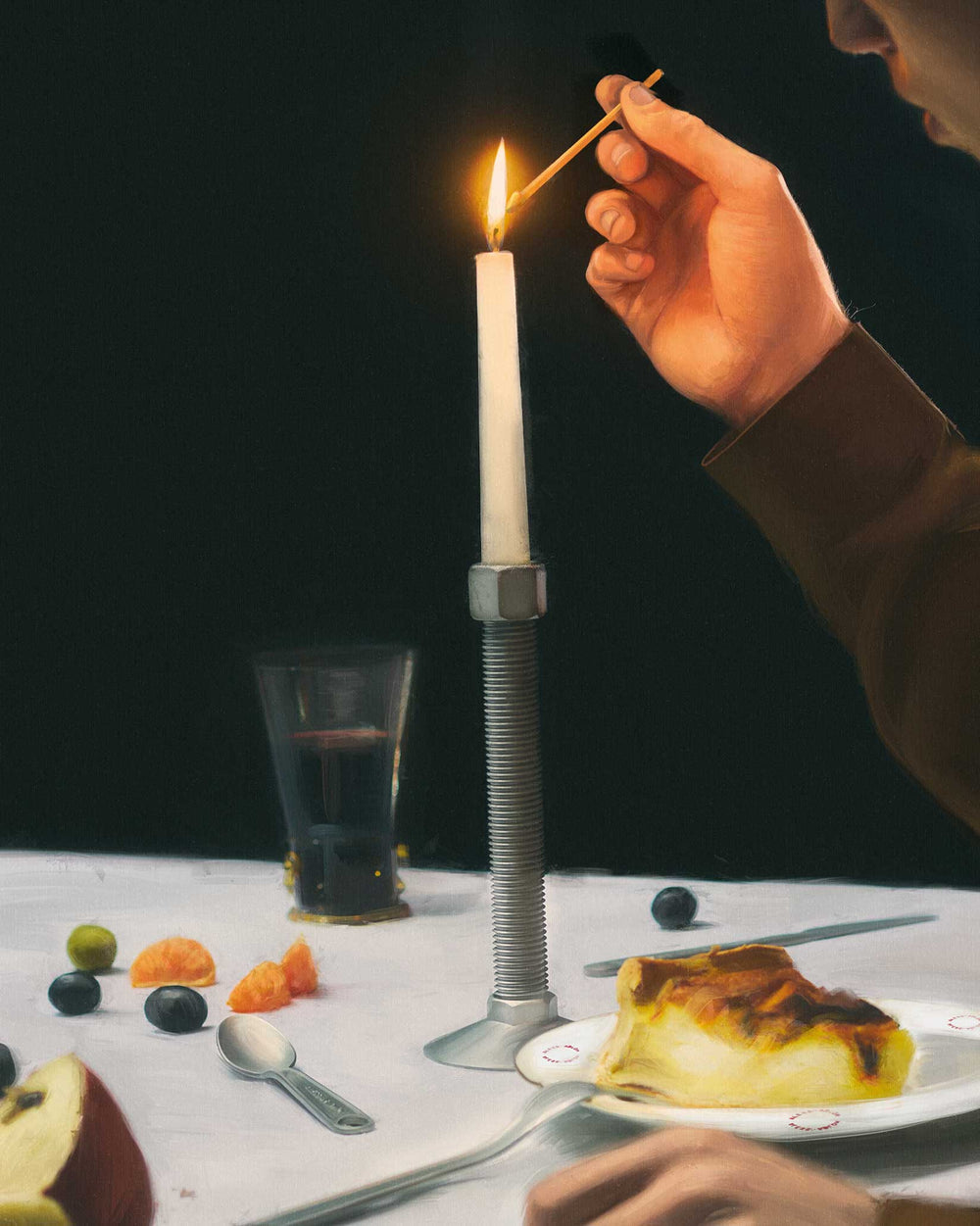 Diverse collection of conversational objects from Alessi, including a lit candle in a unique metal holder, fruit, and dessert on a table.