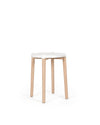 White Poêle Collection stool by Alessi with light wooden legs, featuring a simple, modern design.