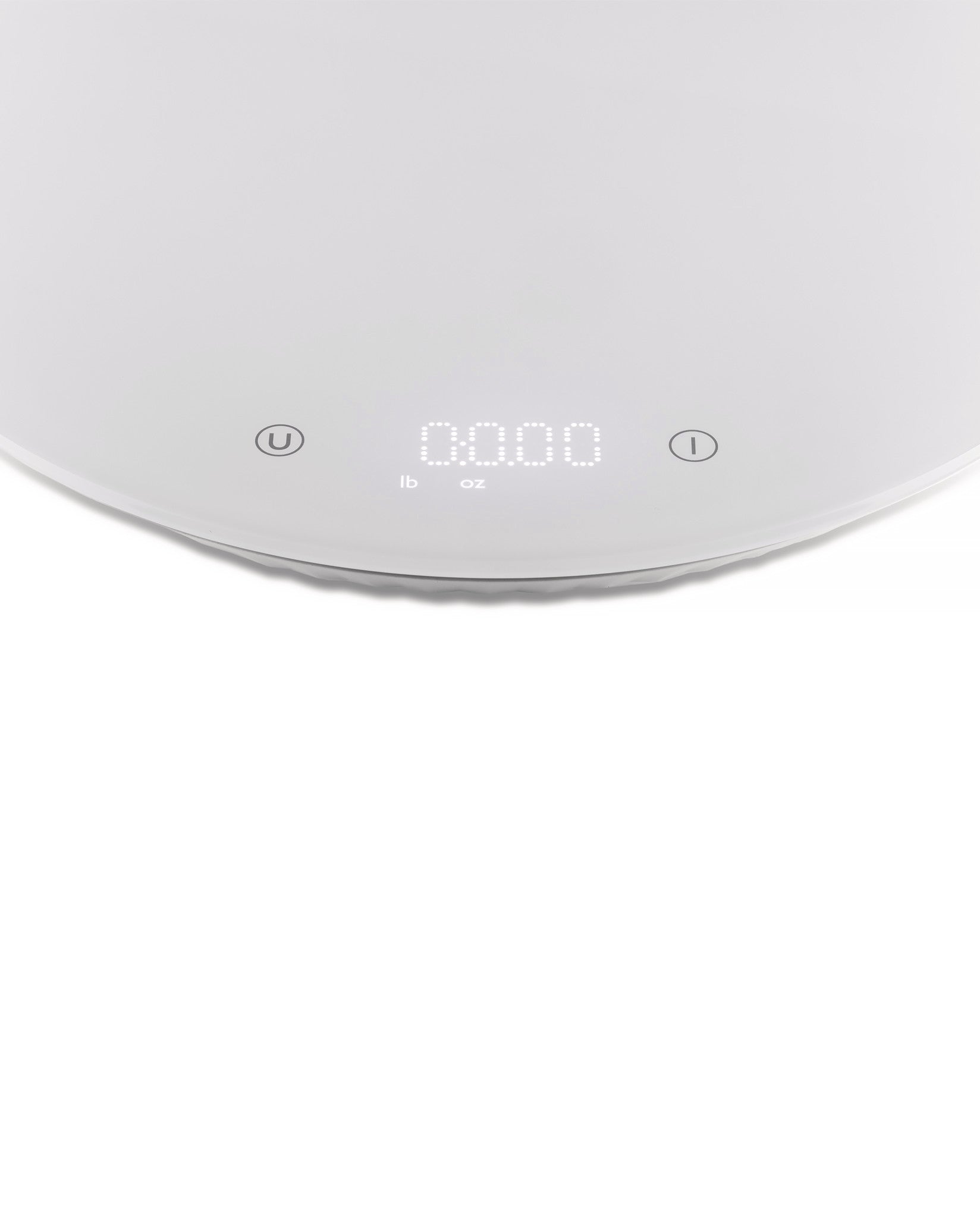 White digital kitchen scale by Alessi with '0.000' displayed, showing lb and oz units, and unit/power buttons.