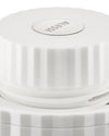 White pleated lid by Alessi with a circular metal logo, shown from an elevated angle.