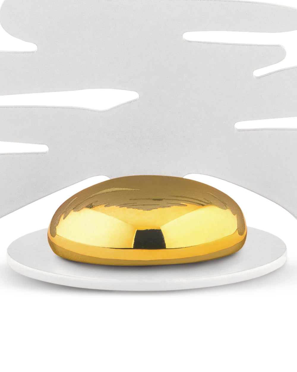 Golden, reflective Barkplace Tree by Alessi, a dome on a white platform against an abstract cutout background.