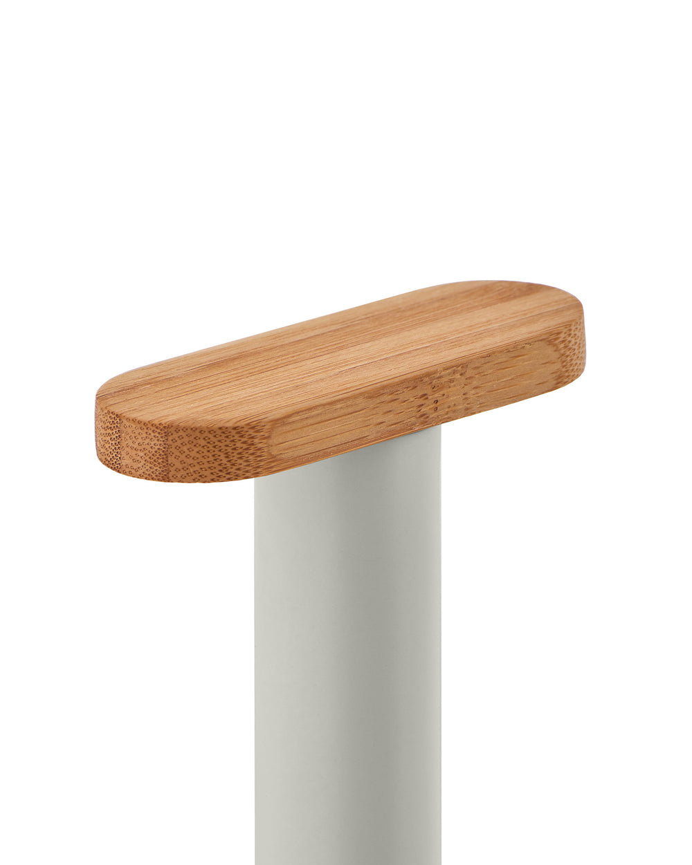 Kitchen roll holder by Alessi with an oval bamboo wood top and matte grey cylindrical base, cropped view.